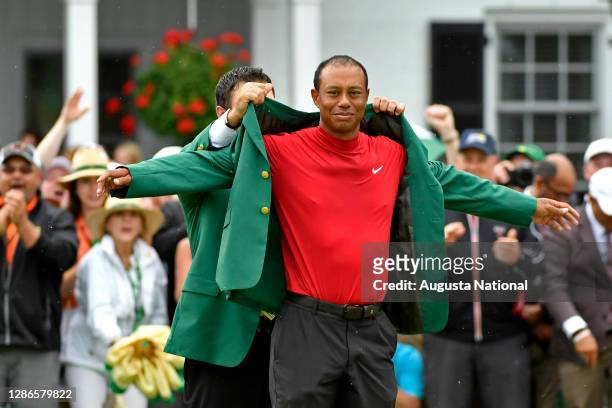 Masters champion Patrick Reed presents Masters champion Tiger Woods with his Green Jacket for winning the Masters during the Green Jacket Ceremony...