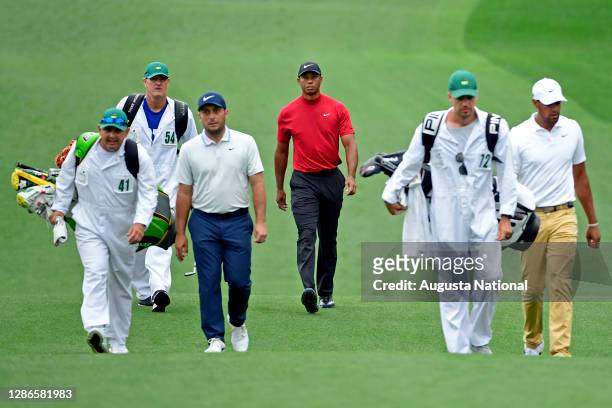Masters champion Tiger Woods walks down hole No. 3 with Francesco Molinari of Italy and Tony Finau during the final round of the Masters at Augusta...