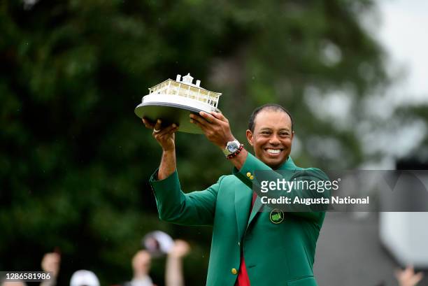 Masters champion Tiger Woods poses with his trophy after winning the Masters at Augusta National Golf Club, Sunday, April 14, 2019.