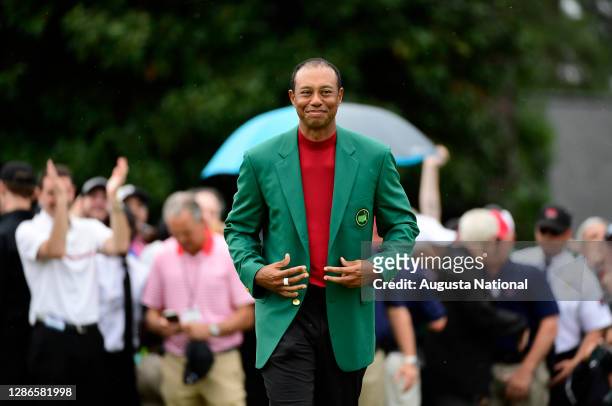 Masters champion Tiger Woods receives his green jacket after winning the Masters at Augusta National Golf Club, Sunday, April 14, 2019.
