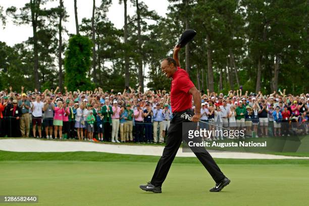 Masters champion Tiger Woods celebrates after he made his putt on hole No. 18 to win the Masters during the final round of the Masters at Augusta...