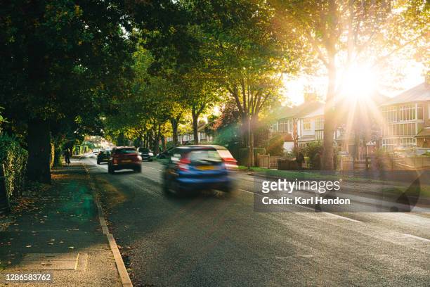 sunset on a surburban street in surrey, uk - traffic stock pictures, royalty-free photos & images