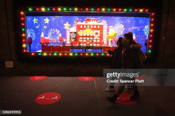 People look at the newly revealed Macy's Herald Square holiday windows on November 19, 2020 in New York City. This year's windows look to give thanks...