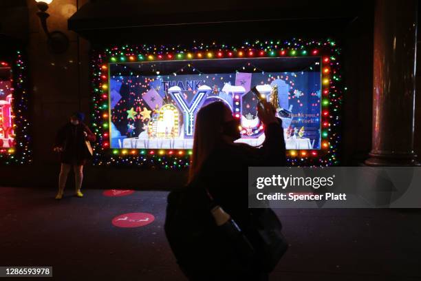 People look at the newly revealed Macy's Herald Square holiday windows on November 19, 2020 in New York City. This year's windows look to give thanks...