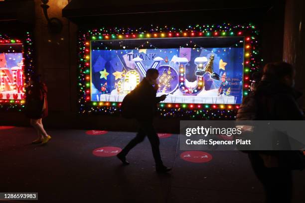 People look at the newly revealed Macy's Herald Square holiday windows on November 19, 2020 in New York City. This year's windows look to give thanks...
