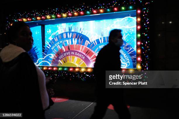 People look at the newly revealed Macy's Herald Square holiday windows on November 19, 2020 in New York City. This year's windows look to give thanks...