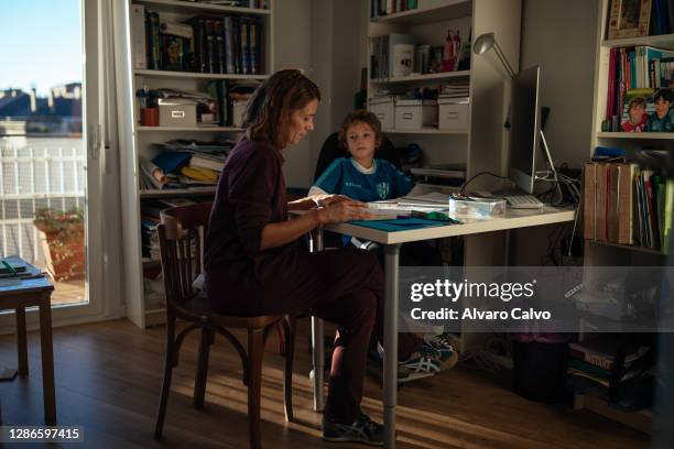 Marta Polo an ICU nurse at the San Jorge Hospital in Huesca, with her son Juan doing his homework on November 19, 2020 in Huesca, Spain. Marta Polo...