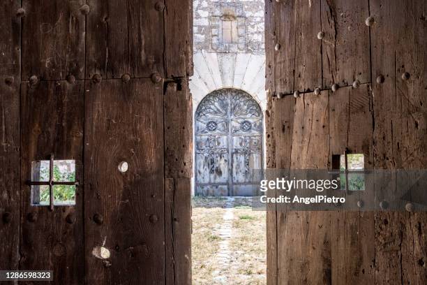 mistery at the other side of the doors - opening doors - old door stock pictures, royalty-free photos & images