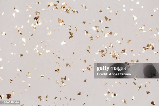 shiny golden confetti falling down. illuminating new year backdrop. - confetti gold ストックフォトと画像