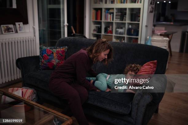 Marta Polo an ICU nurse at the San Jorge Hospital in Huesca, with her son Lucas in the living room of her home before going to work on November 19,...