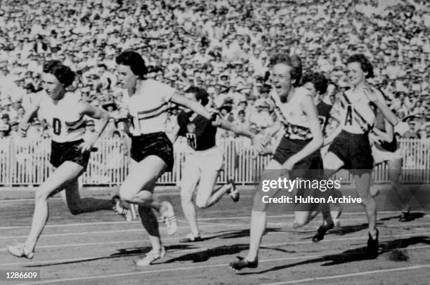 Paul of the British team hands over the batton to her team mate during the Olympis Games in Melbourne, Australia. Australia go on to claim the gold...