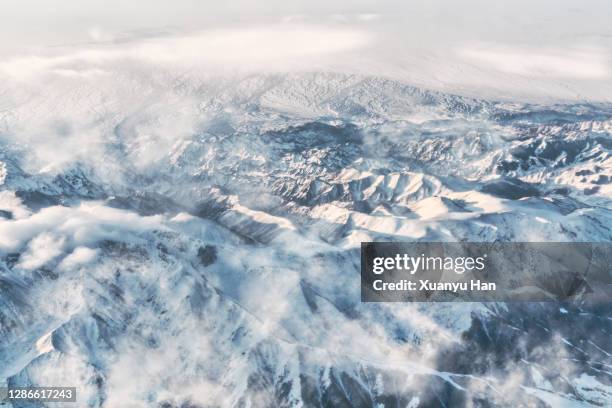 snowcapped mountains landscape from a plane - mountain ridge stock pictures, royalty-free photos & images