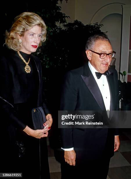 Former Secretary of State Henry Kissinger and his wife Nancy arrive at the White House to attend the State Dinner in honor of Prime Minister Margaret...
