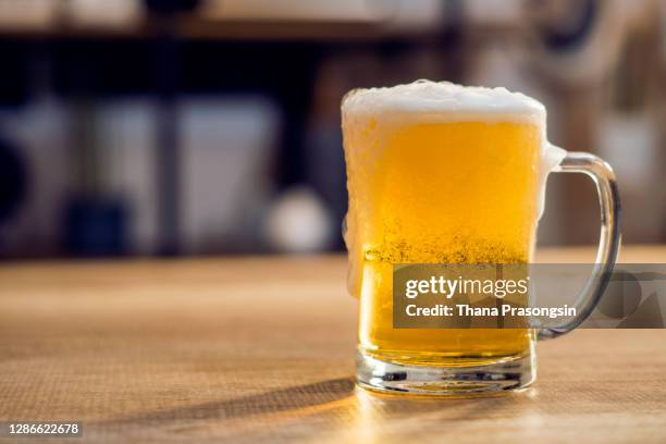 ice cold glass of beer covered with water drops condensation - boccale foto e immagini stock