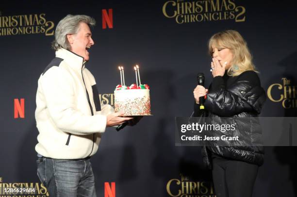 Kurt Russell presents Goldie Hawn with a cake for her milestone birthday at Netflix's "The Christmas Chronicles: Part Two" Drive-In Event at The...