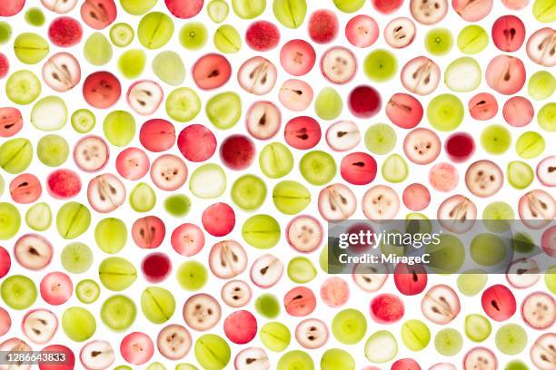 red and white grape slices back lit pattern - druiven stockfoto's en -beelden