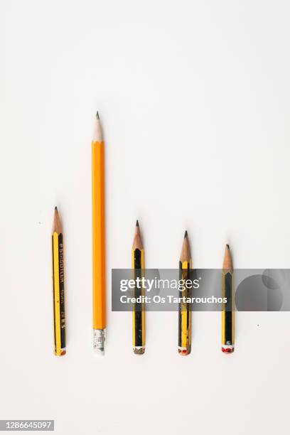 large orange pencil standing out in a row - worn pencil stock pictures, royalty-free photos & images