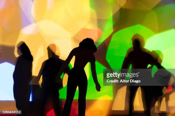 night life: backlit silhouettes of crowd of people. - political party foto e immagini stock