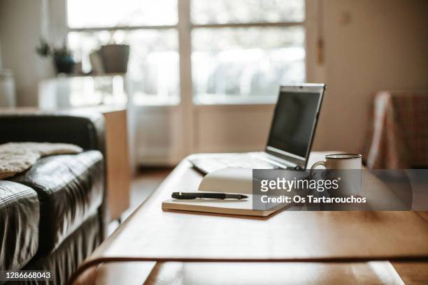 coffee, laptop and a white notebook with a pen ready to work at home - desk stock pictures, royalty-free photos & images