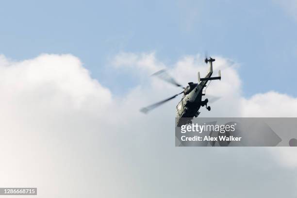 military helicopter against cloudy sky - forze armate britanniche foto e immagini stock
