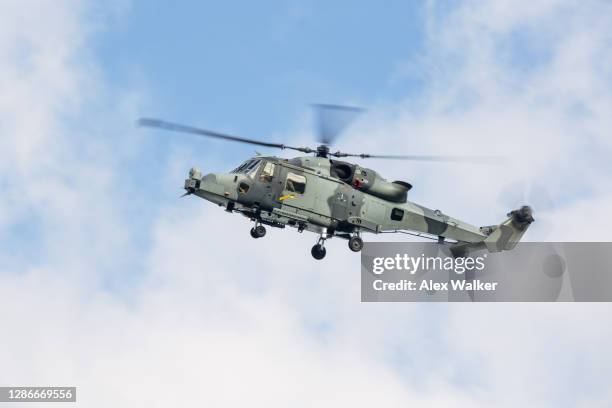 military helicopter against blue cloudy sky. - helicopter rotors stock-fotos und bilder