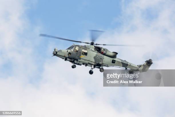 military helicopter against blue cloudy sky. - military helicopter stock pictures, royalty-free photos & images