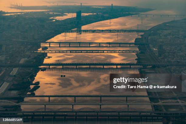 sunset sunbeam on yodo river in osaka city of japan aerial view from airplane - seto inland sea stock pictures, royalty-free photos & images