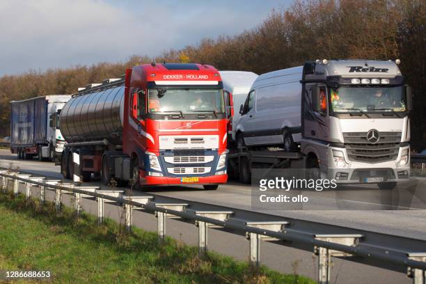 grote vrachtwagens op duitse autobahn - railing stockfoto's en -beelden
