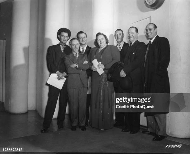 American singer and radio personality Kate Smith poses the cast of 'Command Performance USA,' her US War Department radio program, as they leave CBS...