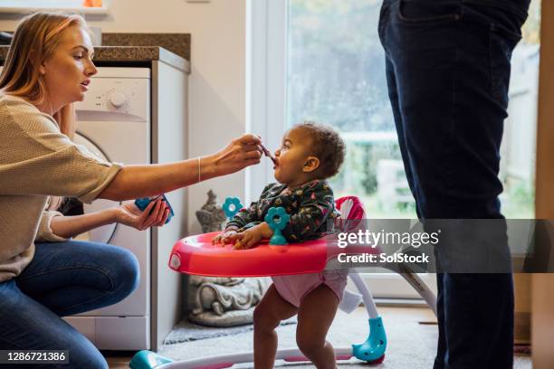 feeding my baby - baby walker stock pictures, royalty-free photos & images