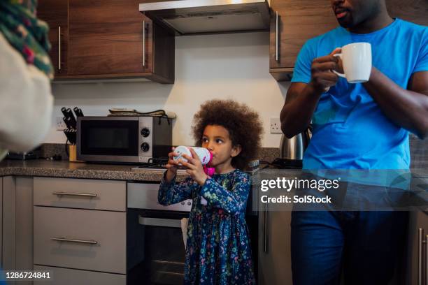 family in the kitchen at home - thirsty stock pictures, royalty-free photos & images