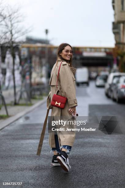 Anna Schürrle wearing red leather Hermes bag, Djerf Avenue sweater, JBrand jeans, Hugo Boss coat and Vans sneaker on November 19, 2020 in Berlin,...
