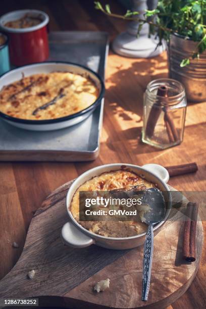 preparing milk rice pudding with vanilla and cinnamon - rice pudding stock pictures, royalty-free photos & images