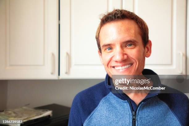 mature trans man portrait smiling in kitchen - autism stock pictures, royalty-free photos & images