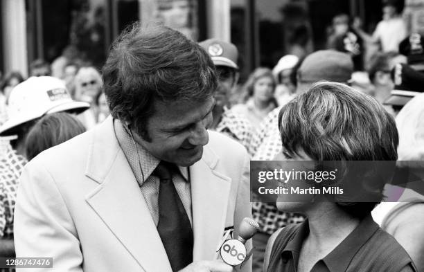 American football player, actor, and ABC television sports commentator Frank Gifford interviews Susie Berning of the United States after she won the...