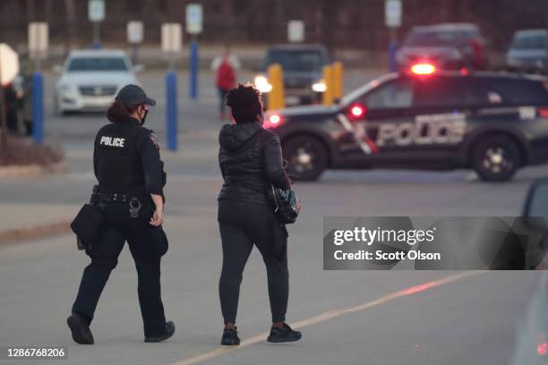 Police secure the scene outside the Mayfair Mall after a gunman opened fire on November 20, 2020 in Wauwatosa, Wisconsin. Several people were...