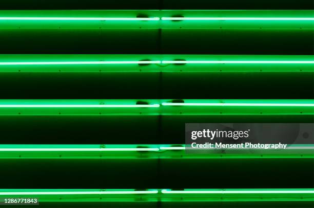 creative abstract colorful green neon lights display - strip lights stock pictures, royalty-free photos & images