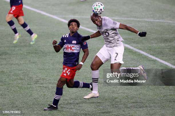 Rod Fanni of Montreal Impact wins the ball out of the air over DeJuan Jones of New England Revolution during second half of the Play-In Round match...