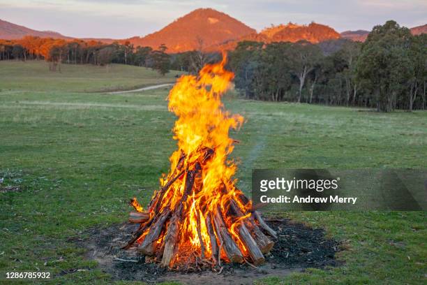bonfire, campfire in green field and mountains - camping new south wales stock pictures, royalty-free photos & images