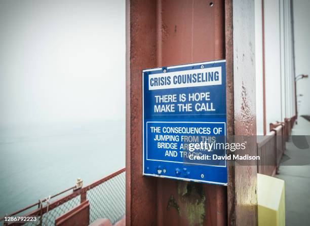 suicide prevention sign on golden gate bridge - suicide prevention stock pictures, royalty-free photos & images