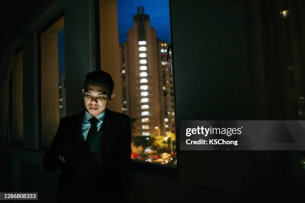 an asian male legal advisors with formal wear and using digital tablet working at evening - formal office stock pictures, royalty-free photos & images