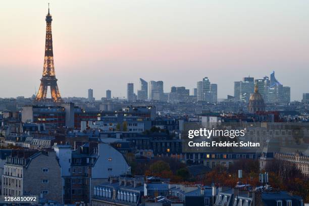 Aerial view of the Eiffel tower and "La Defense", business district in Paris on November 12, 2020 in Paris, France.