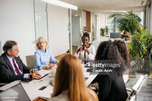 indoor photo business people on a meeting - formal businesswear stock pictures, royalty-free photos & images