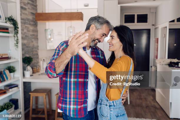 rijp paar in liefde het dansen en het genieten van thuis - couple dancing at home stockfoto's en -beelden