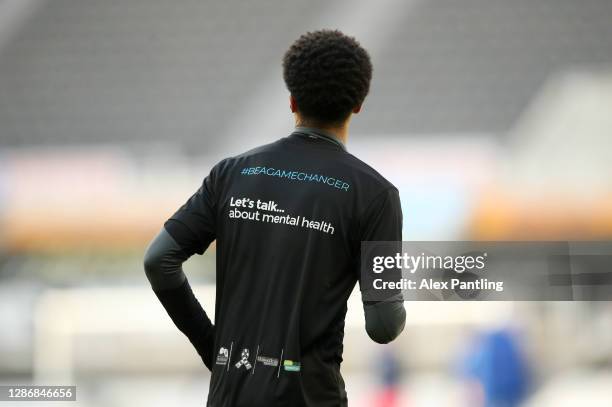 Jamal Lewis of Newcastle United is seen wearing a Be a game changer t-shirt in support of lets talk about mental health prior to the Premier League...