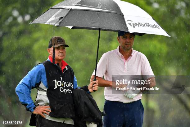 Richard Bland of England stands with his caddie Kyle Roadley on the 11th hole during the third round of the Joburg Open at Randpark Golf Club on...
