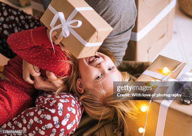 happy father playing with laughing little 5 year old daughter on christmas at home - 2 year old blonde girl father ストックフォトと画像