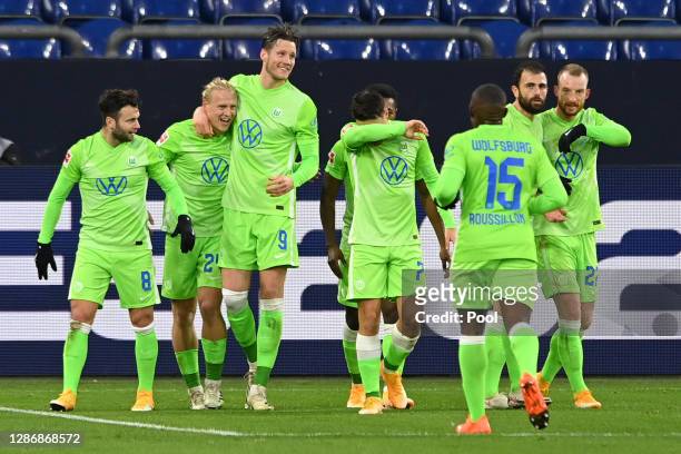 Xaver Schlager of VfL Wolfsburg celebrates with teammates after scoring his team's second goal during the Bundesliga match between FC Schalke 04 and...