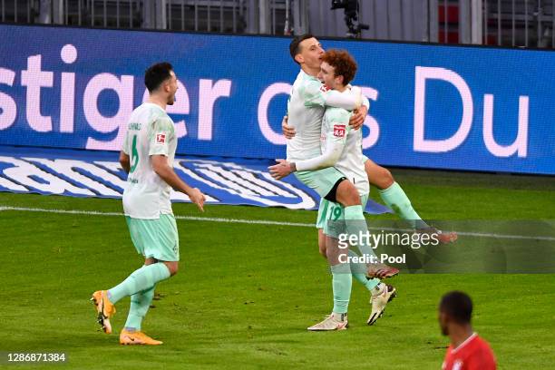 Maximilian Eggestein of Bremen celebrates his team's first goal with teammates Josh Sargent and Kevin Moehwald during the Bundesliga match between FC...