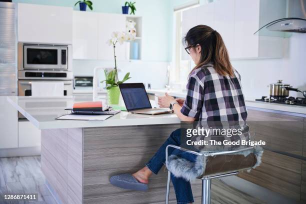 woman working from home in kitchen - legs crossed at knee stock pictures, royalty-free photos & images
